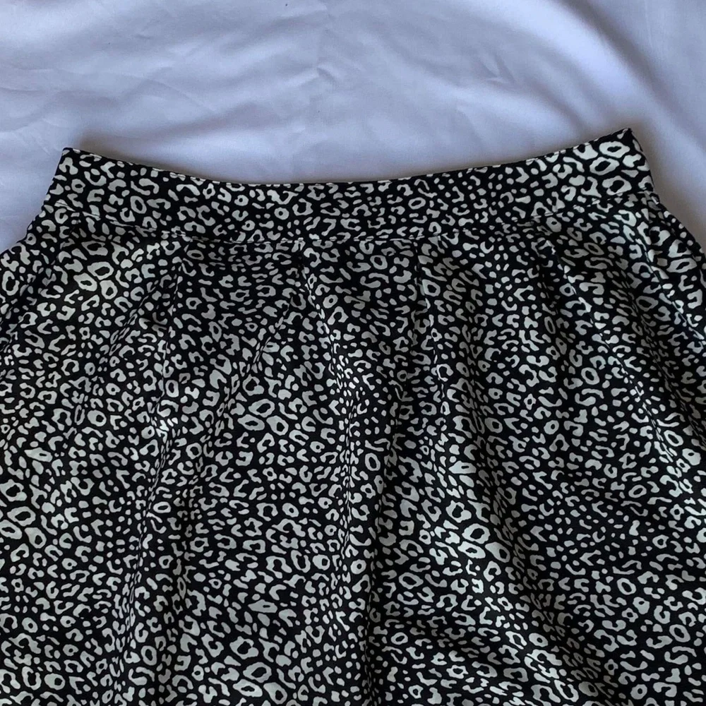 Above the knee black and white skirt